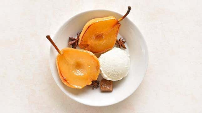 Poached pears in bowl with ice cream