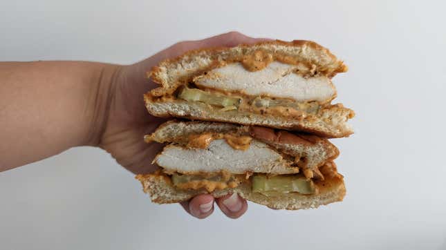 Pollo campero chicken sandwich, sliced in half to show interior