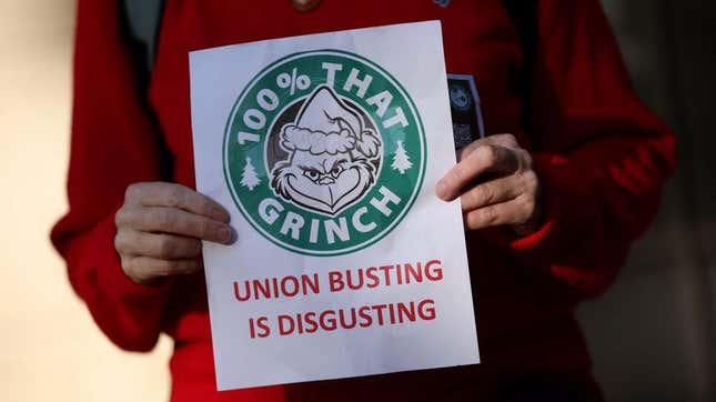 A person holding up a sign in solidarity with Starbucks Workers United on Red Cup Day 2023