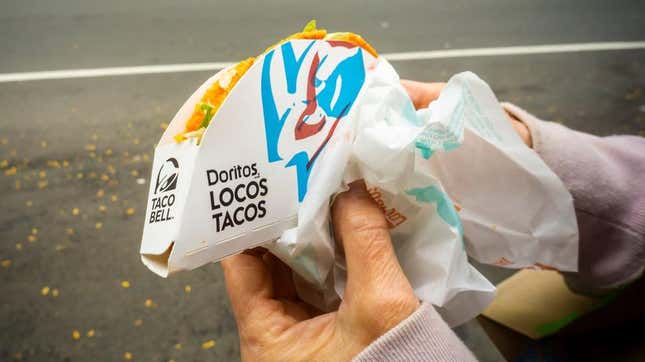 Hand holding Taco Bell Doritos Locos Tacos