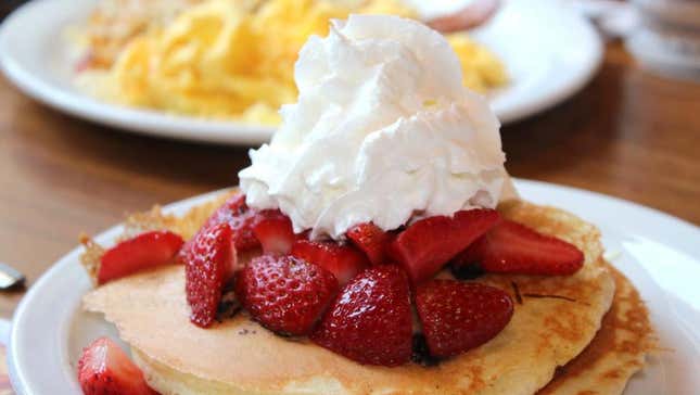 Denny's pancake breakfast with strawberries and whipped cream