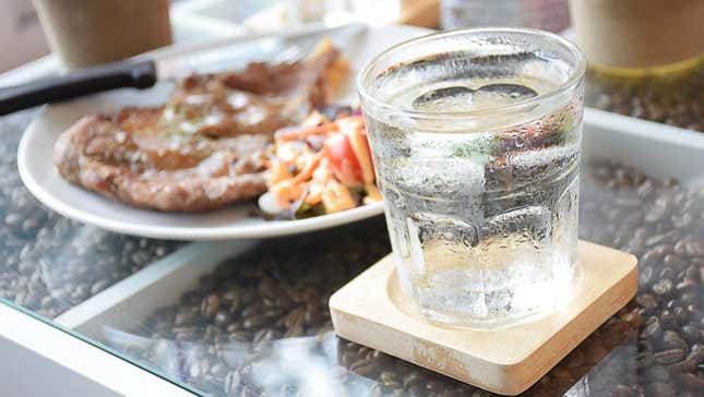 water glass on table with entree at restaurant