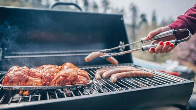 Person grilling meat outdoors