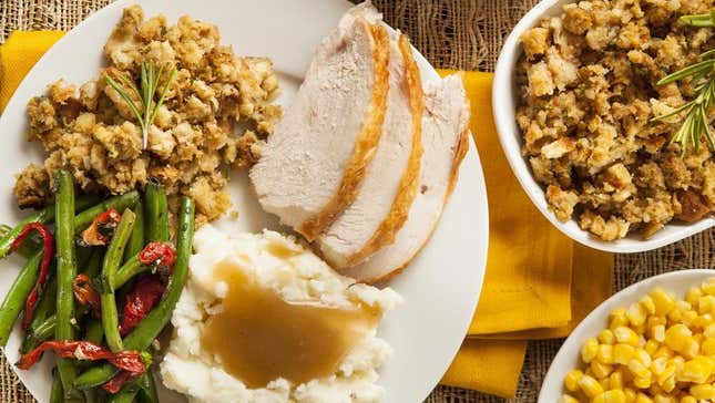 Thanksgiving dinner with turkey, stuffing, green beans, and corn