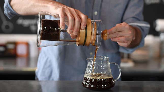 Man pouring cold brew from French press coffee maker